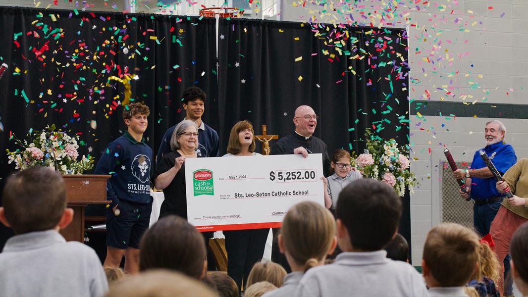 A002_A016_0514ON.0003001-2 Community Coffee Cash for School winners posing with check