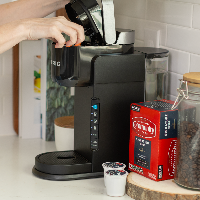 Person brewing iced coffee with Keurig® K-Iced® feature