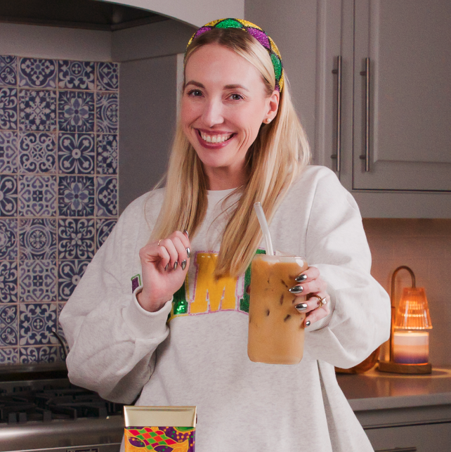 Woman holding glass of cold brewed coffee